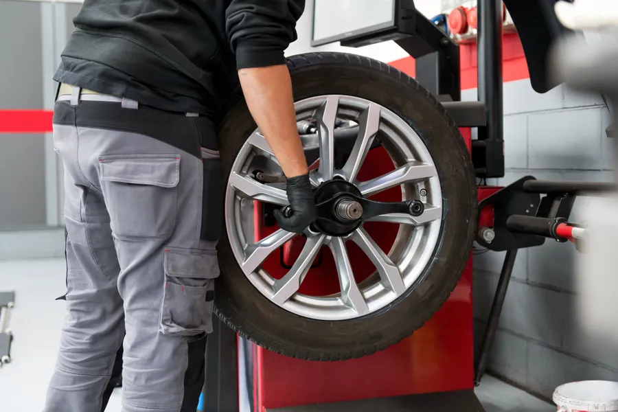 Technician carrying a tire for a tire swap